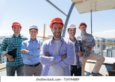 Builders Team Leader Over Group Of Apprentices At Construction Site, Happy Smiling Engineers Workers Teamwork Concept