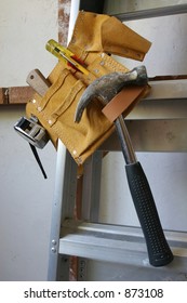 Builders Tool Belt Hanging On A Ladder.