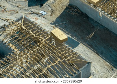 Builders working on roof construction of unfinished residential house with wooden frame structure in Florida suburban area. Housing development concept - Shutterstock ID 2359380629