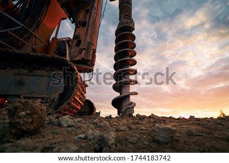 Building activity on contruction site. Close-up view of drilling machine.  