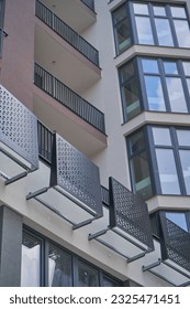                      the building of an apartment complex with installed windows and railings          
