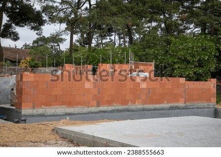building brick walls with cement and mortar in house construction site