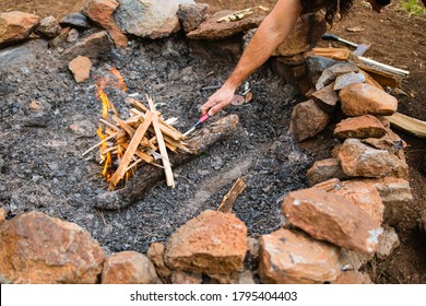 Building A Campfire While Camping During The Summer.