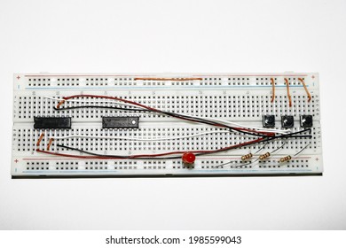 
Building a Circuit on Breadboard. Build a circuit on a breadboard using integrated circuits, resistors, buttons, and LED.