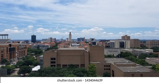 Building In The City Of Austin With The UT Tower And A Crane.