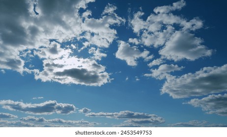 Building clouds and sun rays breaking through cloud mass. Flares shinning through dramatic clouds. Timelapse.