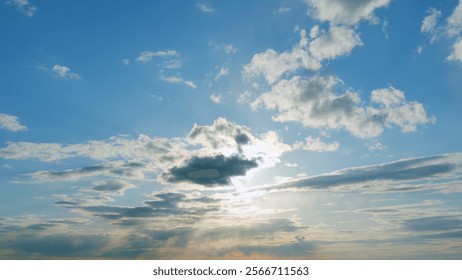 Building clouds and sun rays breaking through cloud mass. Flares shinning through dramatic clouds. Timelapse.