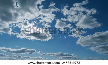 Building clouds and sun rays breaking through cloud mass. Flares shinning through dramatic clouds. Timelapse.
