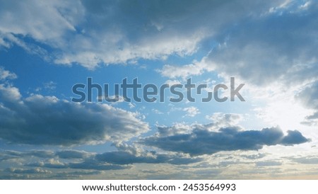 Building clouds and sun rays breaking through cloud mass. Flares shinning through dramatic clouds. Timelapse.
