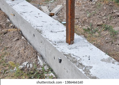 Building concrete foundation for new fence. House concrete fencing construction