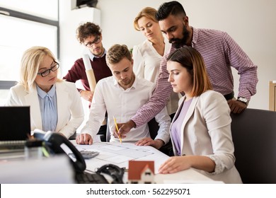 Building, Construction, Architecture, Real Estate And People Concept - Business Team With Blueprint Meeting And Discussing House Project At Office