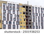 Building construction, insulation and cladding facade wall. Thermal insulation, warming of external walls with mineral wool. Ventilated facade insulation, partially attached facade cladding panels