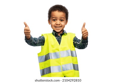 building, construction and profession concept - happy smiling little boy in yellow safety vest showing thumbs up gesture over white background