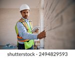 Building contractor using digital tablet during construction site inspection. Copy space.