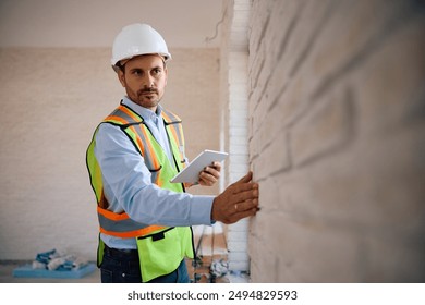 Building contractor using digital tablet during construction site inspection. Copy space. - Powered by Shutterstock