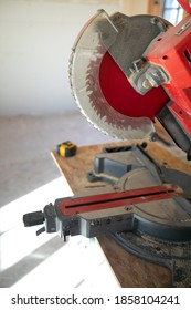 Building contractor worker using hand held circular saw to cut boards on a new home constructiion project sit