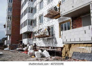 Building cradle on the facade of the building under construction - Shutterstock ID 607255598