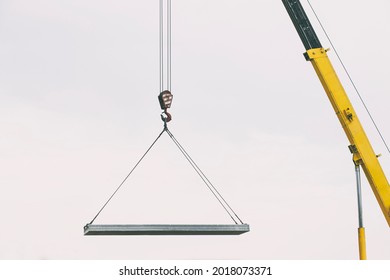 The building crane lifting the concrete plate - Powered by Shutterstock