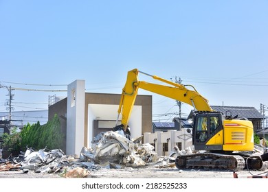 Building demolition work. A crane that destroys buildings and carries rubble. - Shutterstock ID 2182525233