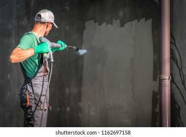 Building Elevation Pressure Washing By Worker With Power Washer. Refreshing House Outside Walls.