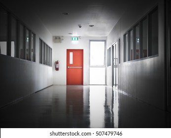 Building Emergency Exit With Exit Sign On Door And Fire Extinguisher