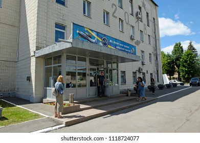 Building And Entrance To The Checkpoint Of The State Aircraft Repair Plant “410”, People Walking Through The Door. Press-tour To The State Aircraft Repair Plant “410”. June 7, 2018. Kiev, Ukraine