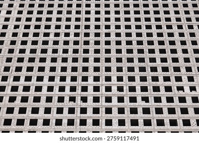 Building facade forming a grid pattern with repetitive window openings