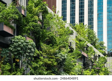 Building facade with green plants growth on the wall. Vertical garden in Kuala Lumpur city, Malaysia. Eco friendly urban environment. Sustainable modern and ecological architecture - Powered by Shutterstock