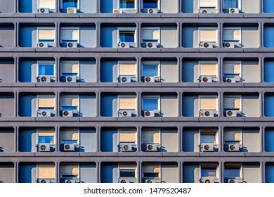 Building facade pattern with rounded frames and air conditioners