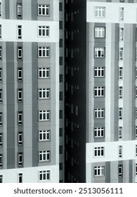 The building features a striped pattern with alternating light and dark gray vertical sections. The design has a geometric, minimalistic aesthetic.