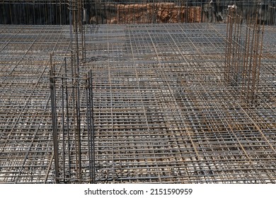 Building foundation with steel reinforcement bars at construction site. 