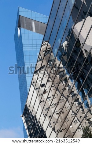 Building with glass facade on sophisticated Faria Lima Avenue, a major office center. Sao Paulo city, Brasil