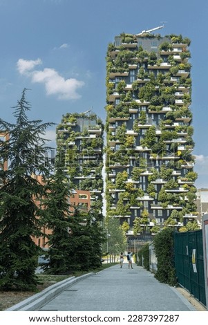 A building with a green facade and plants on the side. Bosco Verticale (Vertical Forest) in Milan city, Italy