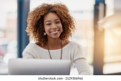 Building her business on success at a time. Portrait of a young businesswoman sitting at her laptop in an office.