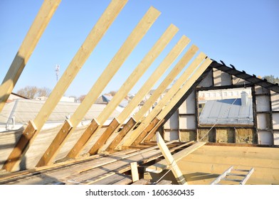 Building A House After A Fire. New Wooden Rafters. Charred Boards