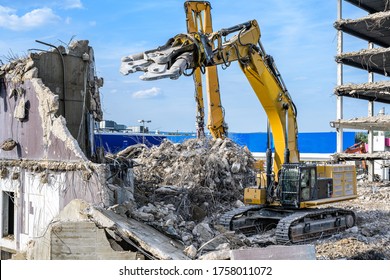 Building House destruction Demolition site Excavator with hydraulic crusher machine ruin house