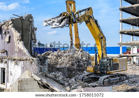 Building House destruction Demolition site Excavator with hydraulic crusher machine ruin house