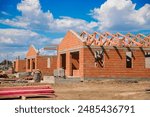 Building a house. The frame of the house. Cottage. The beginning of the construction of the cottage. The house is made of red brick with a frame for the future roof