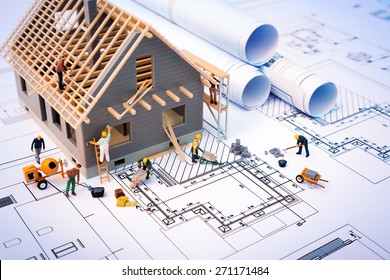 building house on blueprints with worker - construction project
