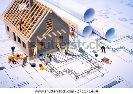 building house on blueprints with worker - construction project

