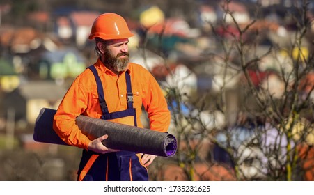 Building House. Roofer Repair Roof. Roof Installation. Man Hard Hat Work Outdoor Landscape Background. Apply Plastic Coatings Membranes Fiberglass Or Felt Over Sloped Roofs Before Applying Shingles.