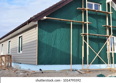 Building House With Wall Insulation, Waterpfoof Membrane, Plastic Siding, Guttering And Foundation Insulation With Styrofoam. Siding House, Siding Installation.