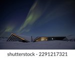 Building of Ilulissat Icefjord visitor center by night with northern lights above