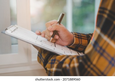 Building inspection, asian contractor young man, male inspecting home, reconstructed construction, renovation or check defect, before finish handing it over to client, customer. Engineering worker. - Shutterstock ID 2071889060