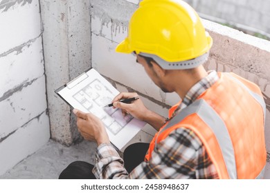 Building inspection asian contractor young man, male inspecting home, reconstructed construction, renovation or check defect, before finish handing it over to client, customer. Engineering worker. - Powered by Shutterstock