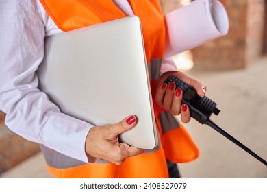 Building inspector using portable two-way radio and computer on site
