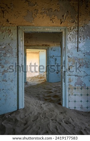 A building in Kolmanskop ghost town, an abandoned German colonial-era settlement, slowly being taken over by surrounding desert sands, Luderitz, Namibia