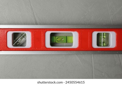 Building level on grey table, top view