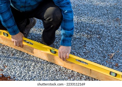 Building level surface on which to place gravel for foundation of shed in backyard.