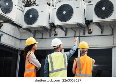 Building, looking and employees doing maintenance inspection on warehouse air together. Safety, engineering and handyman with contractor women or analysis of construction repairs at a factory - Powered by Shutterstock